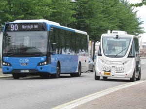 Perinteinen bussi ja vierellä moderni tietokoneohjattu minibussi.