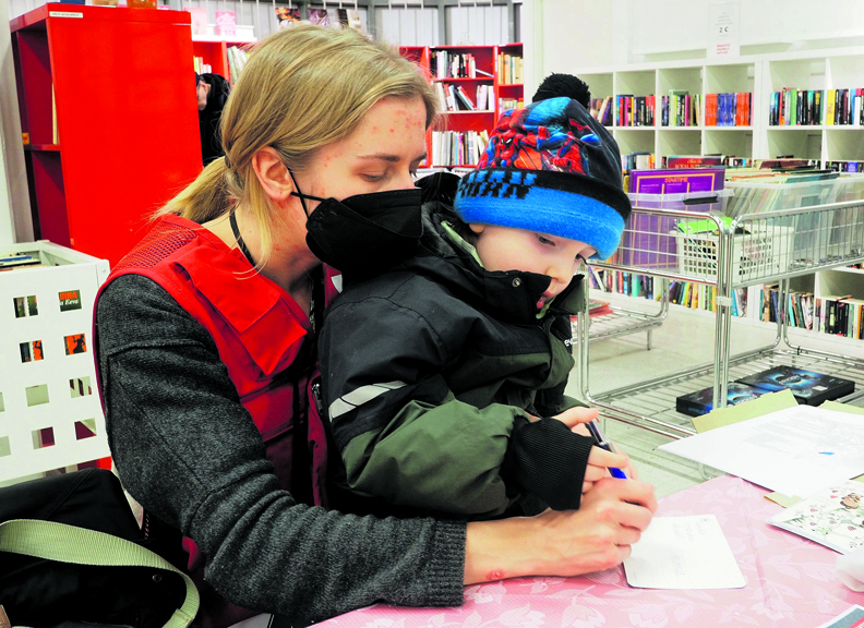Roosa Laaksonen auttoi kolmevuotiasta Melviniä ystävänpäiväkortin tekstin muotoilussa.