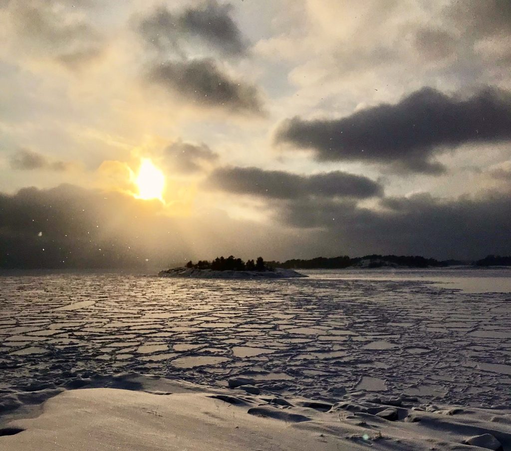 Läntisen taivaan auringonlaskusta ja jäätyneen meren jäälautoista muodostui kaunis hetki Uutelassa 24.1. Kuva: Tuomo Holopainen